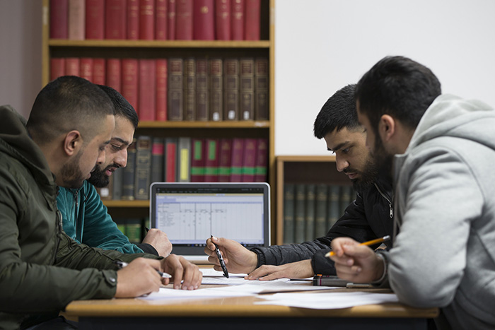 Students working on an assessment in the library