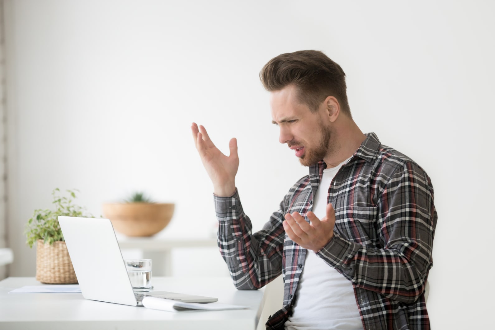 person in front of computer frustrated