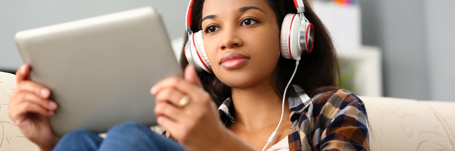 Student with tablet and headphones.