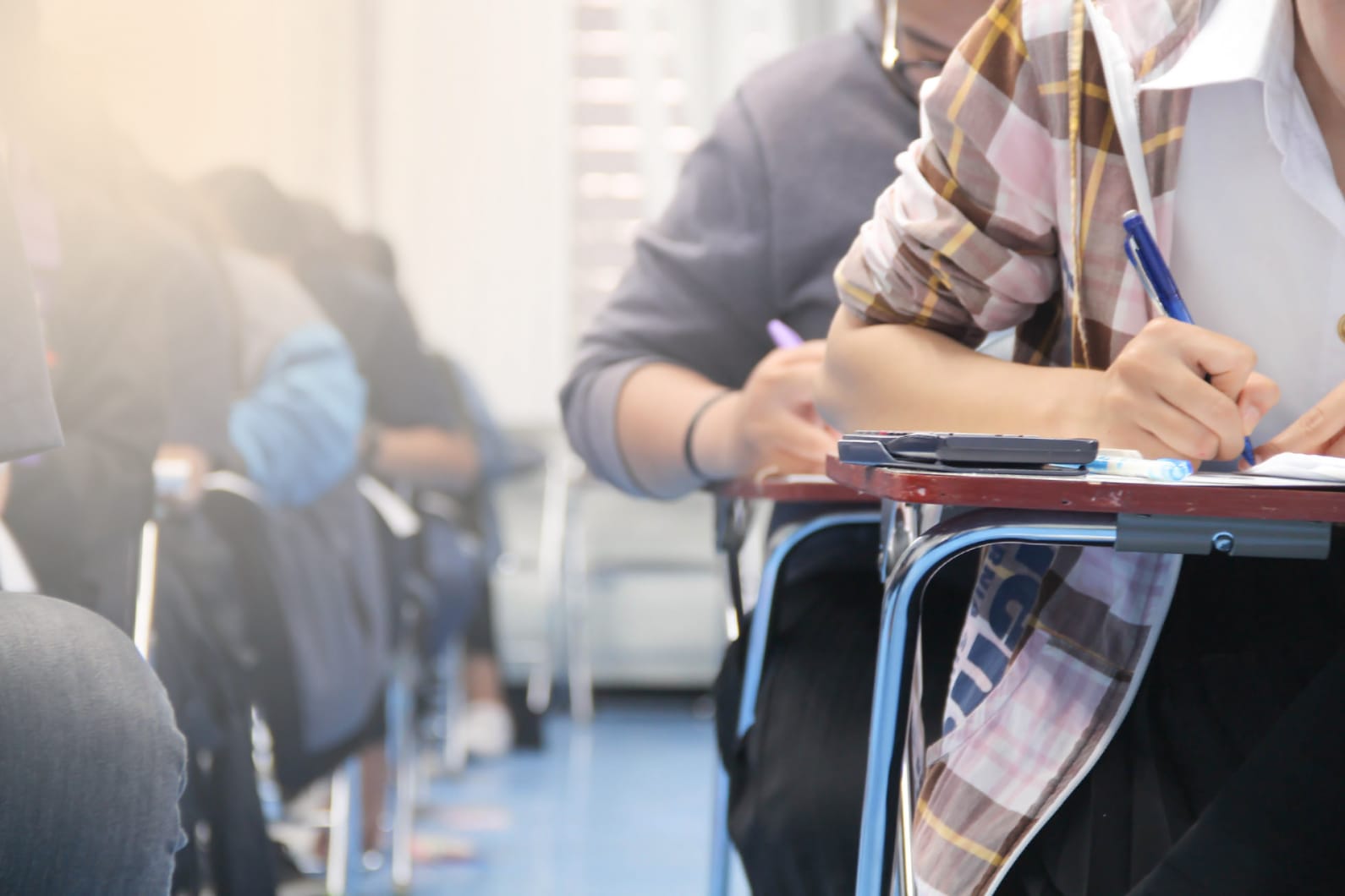 students at desks taking exams