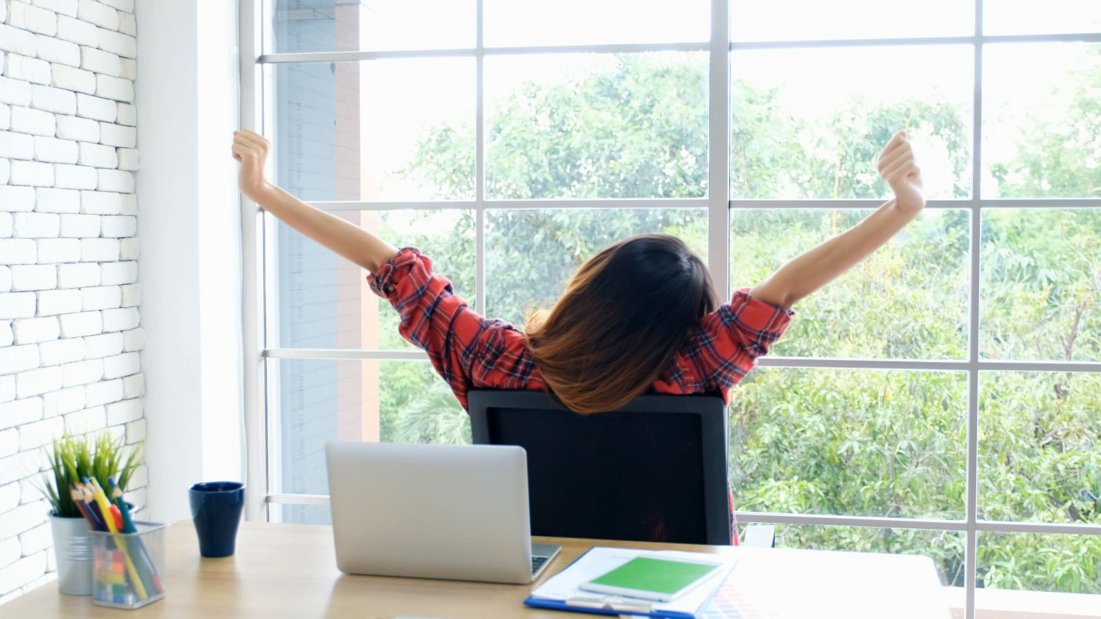 Student sitting in a computer chair stretching