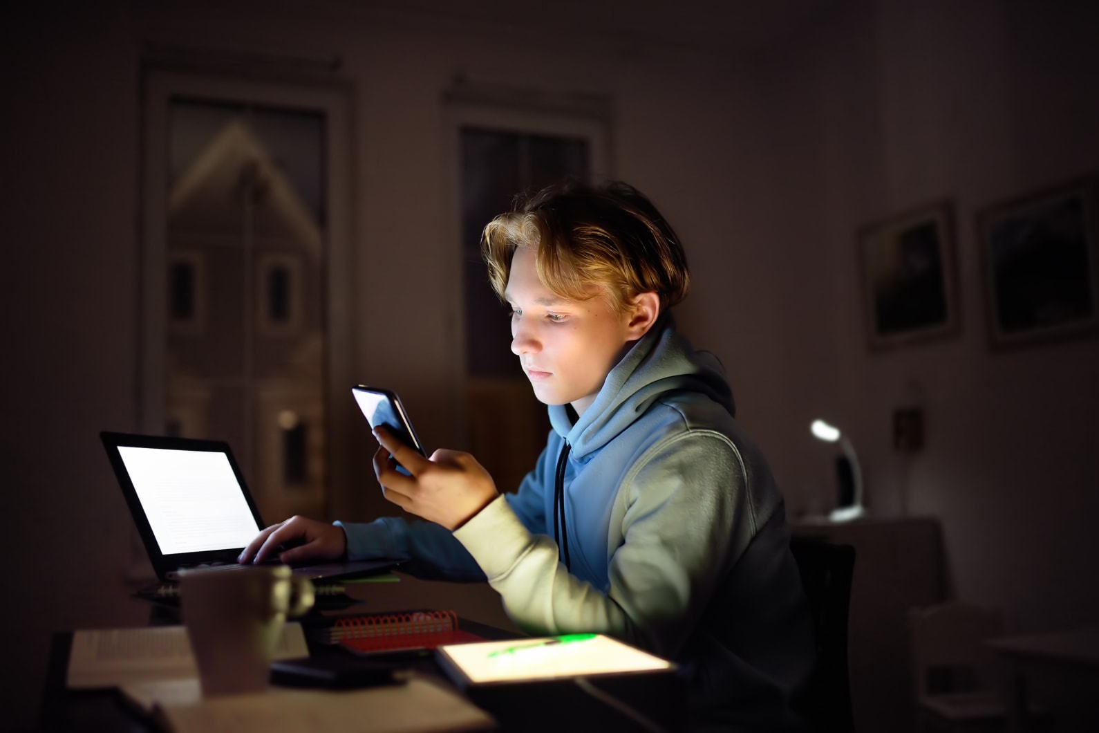 student multitasking on phone and computer