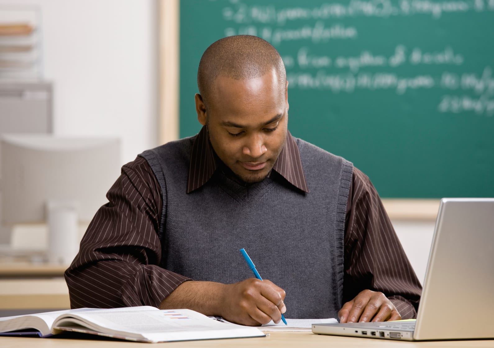 student studying at a desk in front of a computer