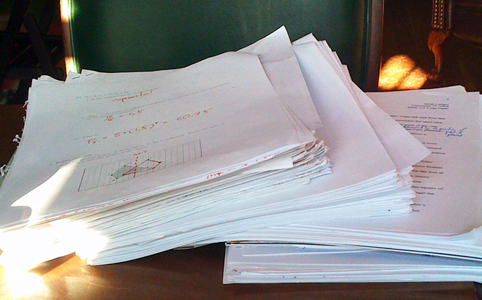 Pile of paper assessments ready for grading