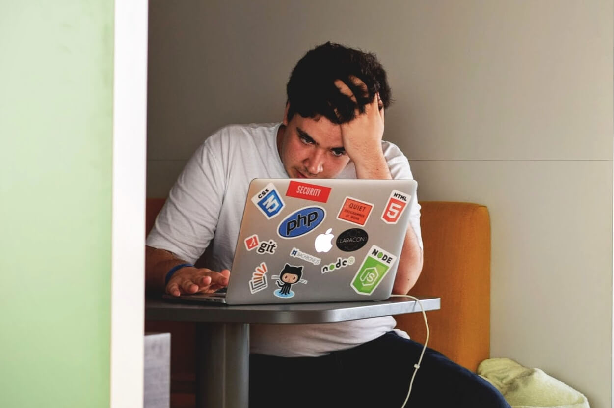 Student concentrating while working on a laptop