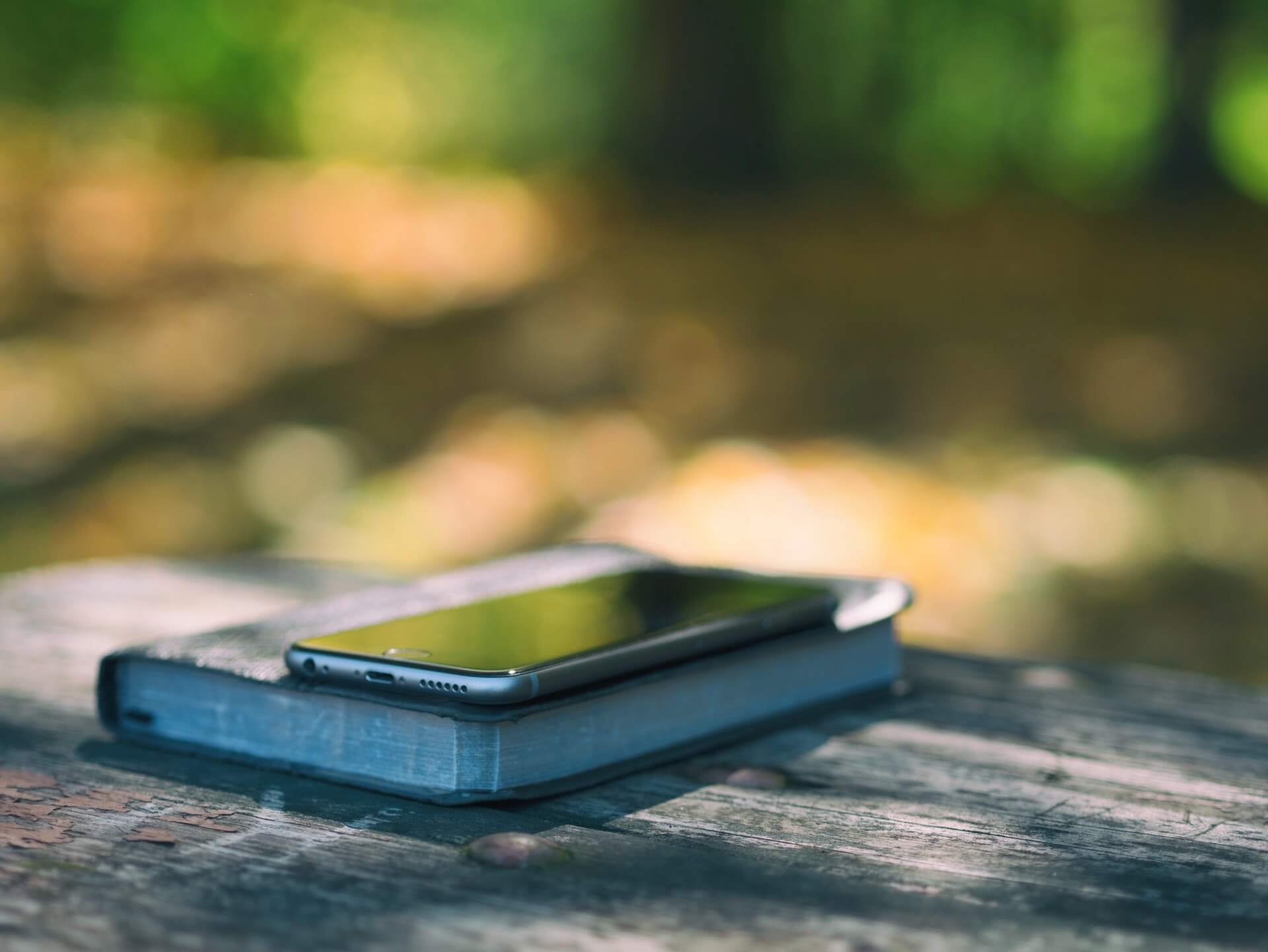 Smartphone lying on a stack of books