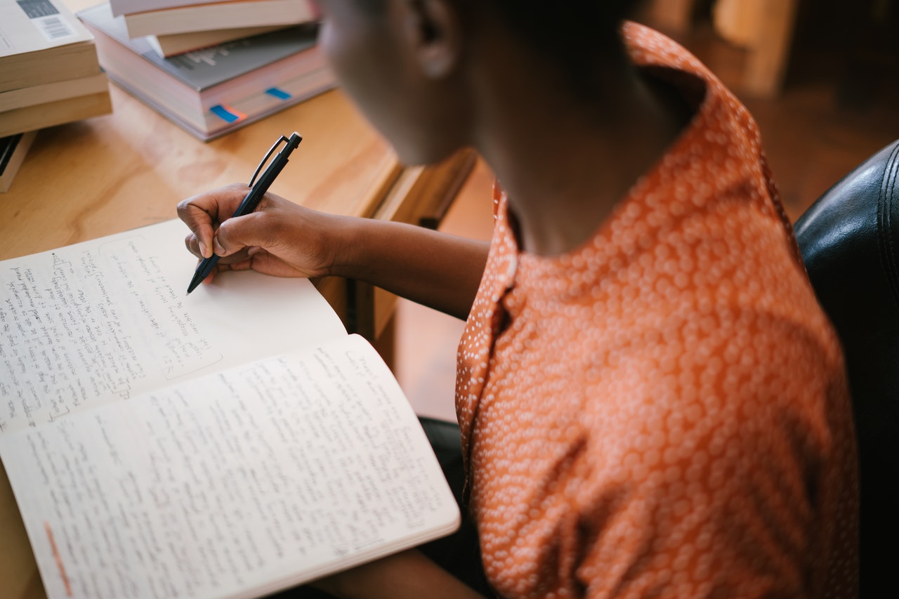 Person writing in notebook