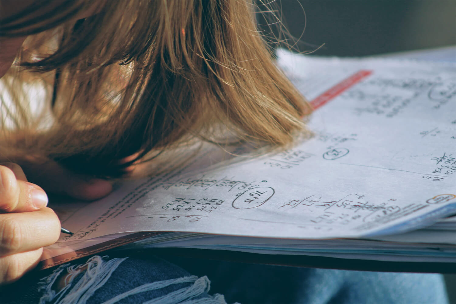 Close up of a student handwriting and answer on a piece of paper