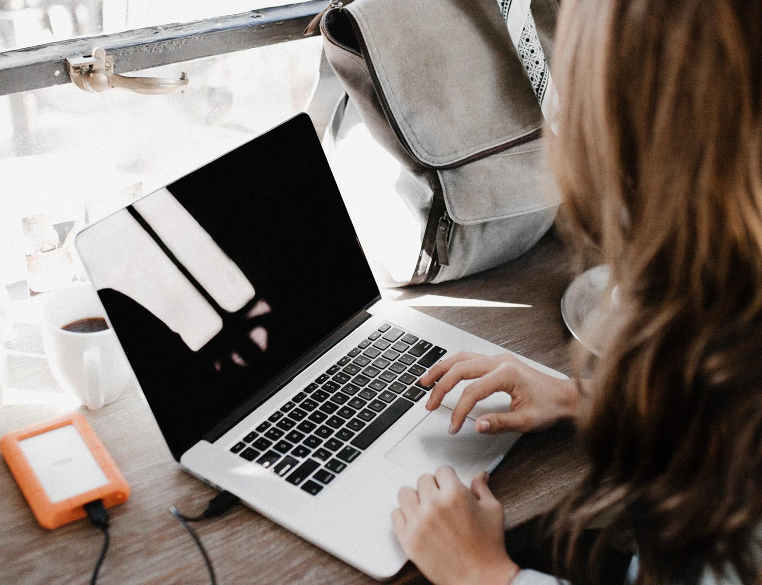 Woman working on a laptop at a desk