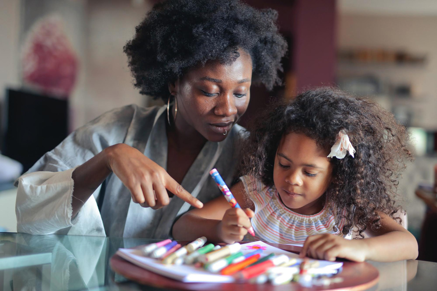 A teacher helping a student with an art project