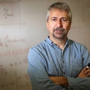 Photograph of Professor Robert Craigen in front of whiteboard.