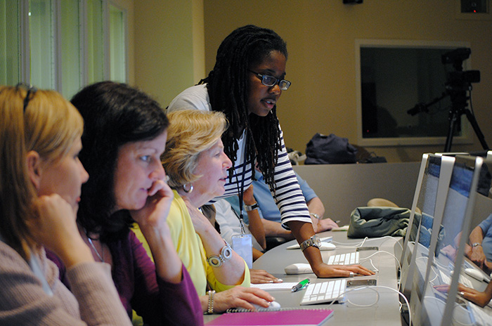 Teachers assessing new technology in a meeting