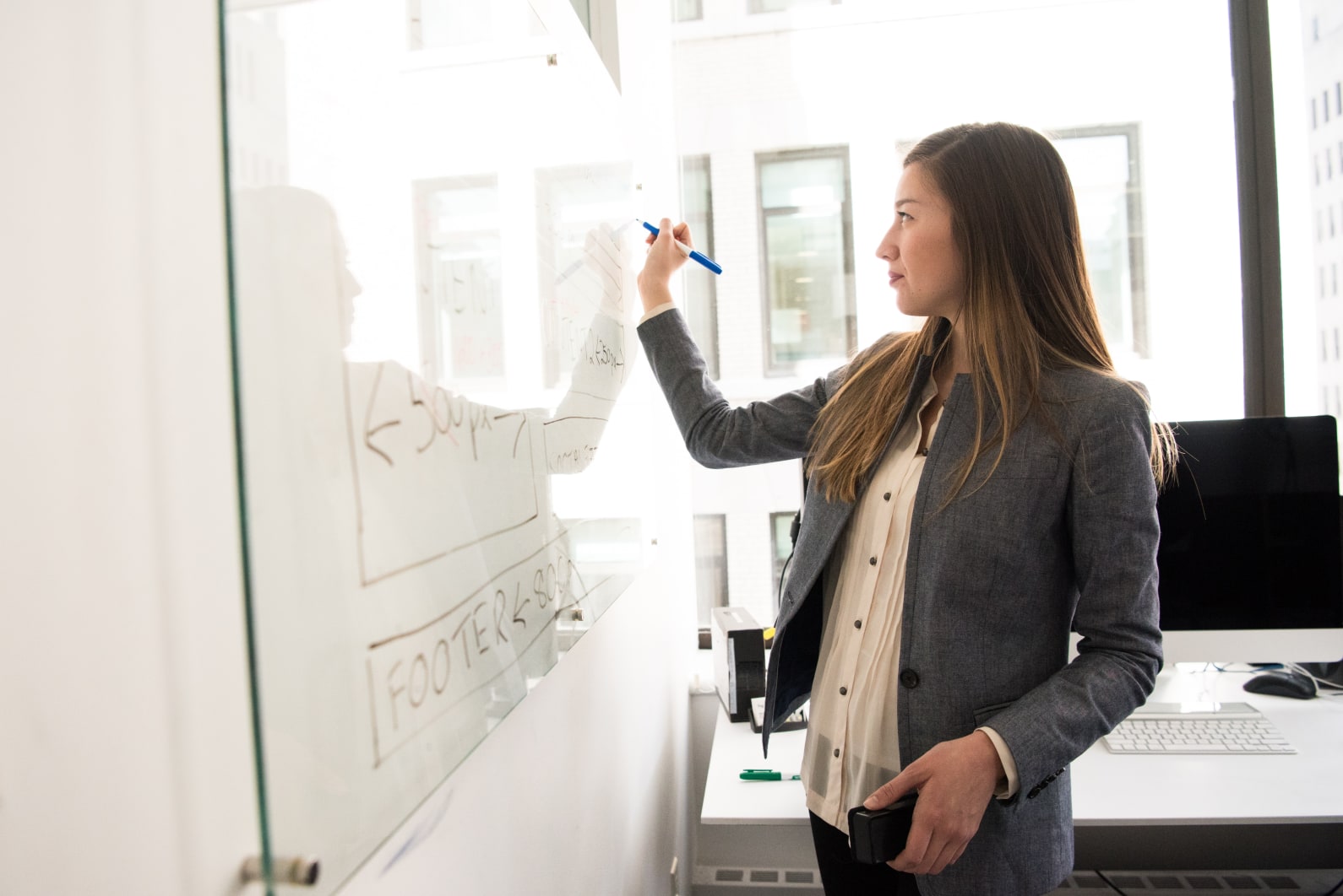 Women drawing on a whiteboard