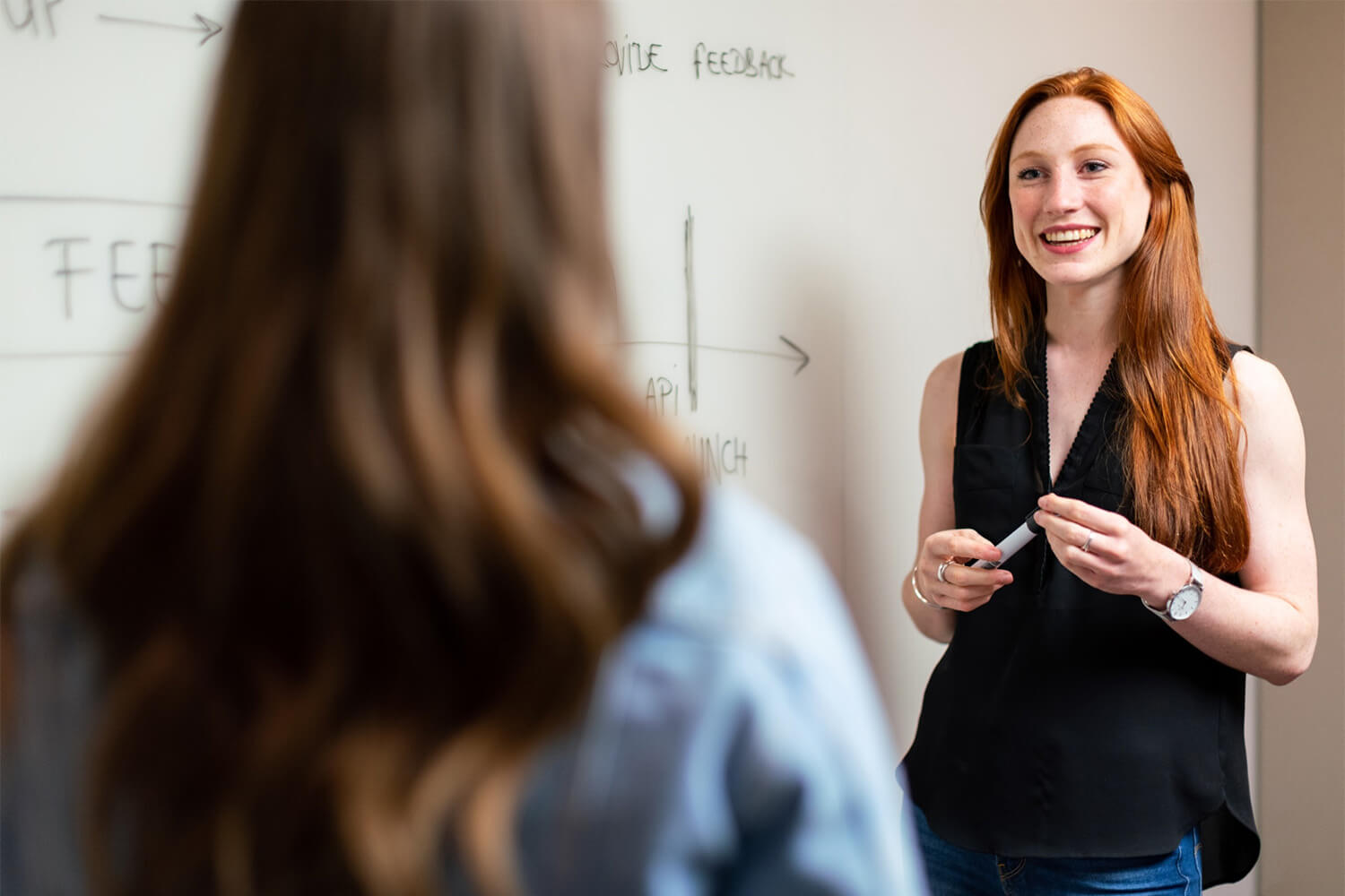 Teacher talking to a student at the whiteboard