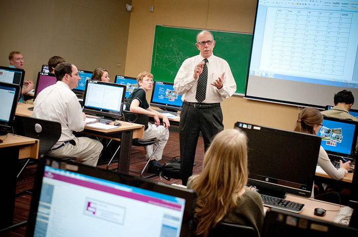 Instructor teaching a class on students