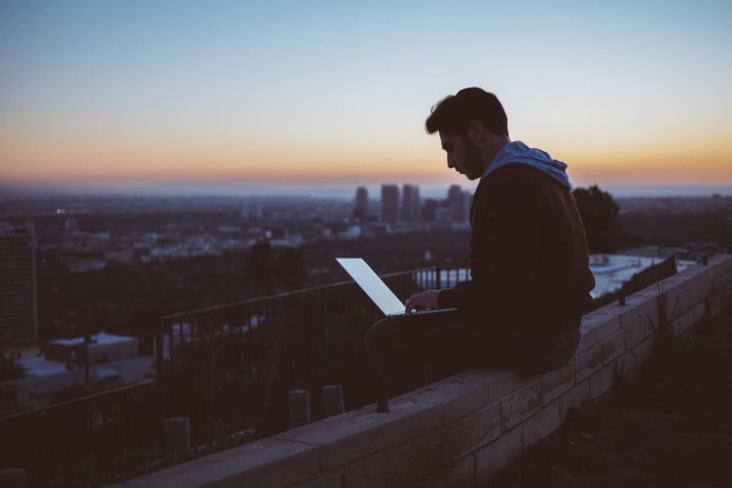 Student studying using a laptop outdoors