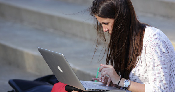 Student sitting with laptop.