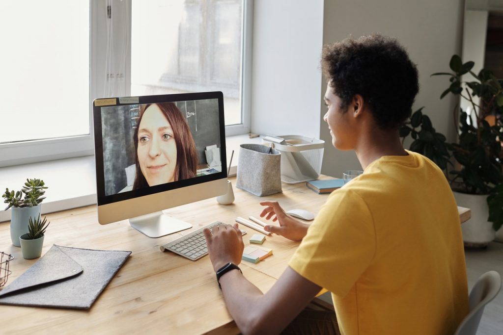 woman looking at other person on computer